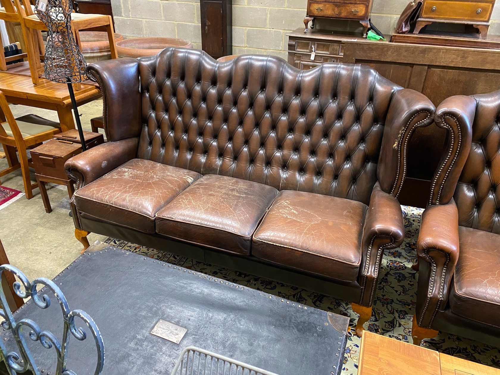 A Victorian style button brown leather three piece suite
